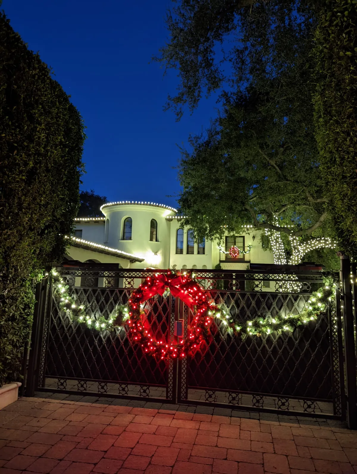 Holiday wreath and garland lighting on gated entrance in Cobb County